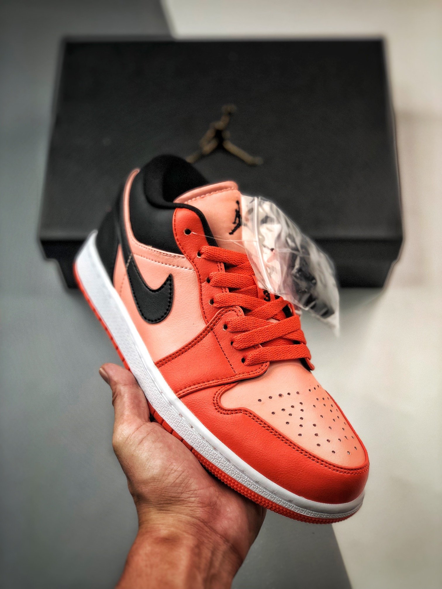 black and orange jordan 1 low